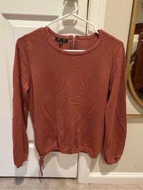 Women's Crewneck Knit Top in Burnt Orange with tie hem and zip back